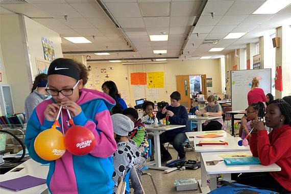 Golden Ring Middle School students replicate the respiratory system using balloons, straws and tape.